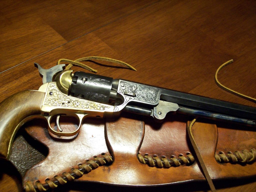 Pistol with leather holster.